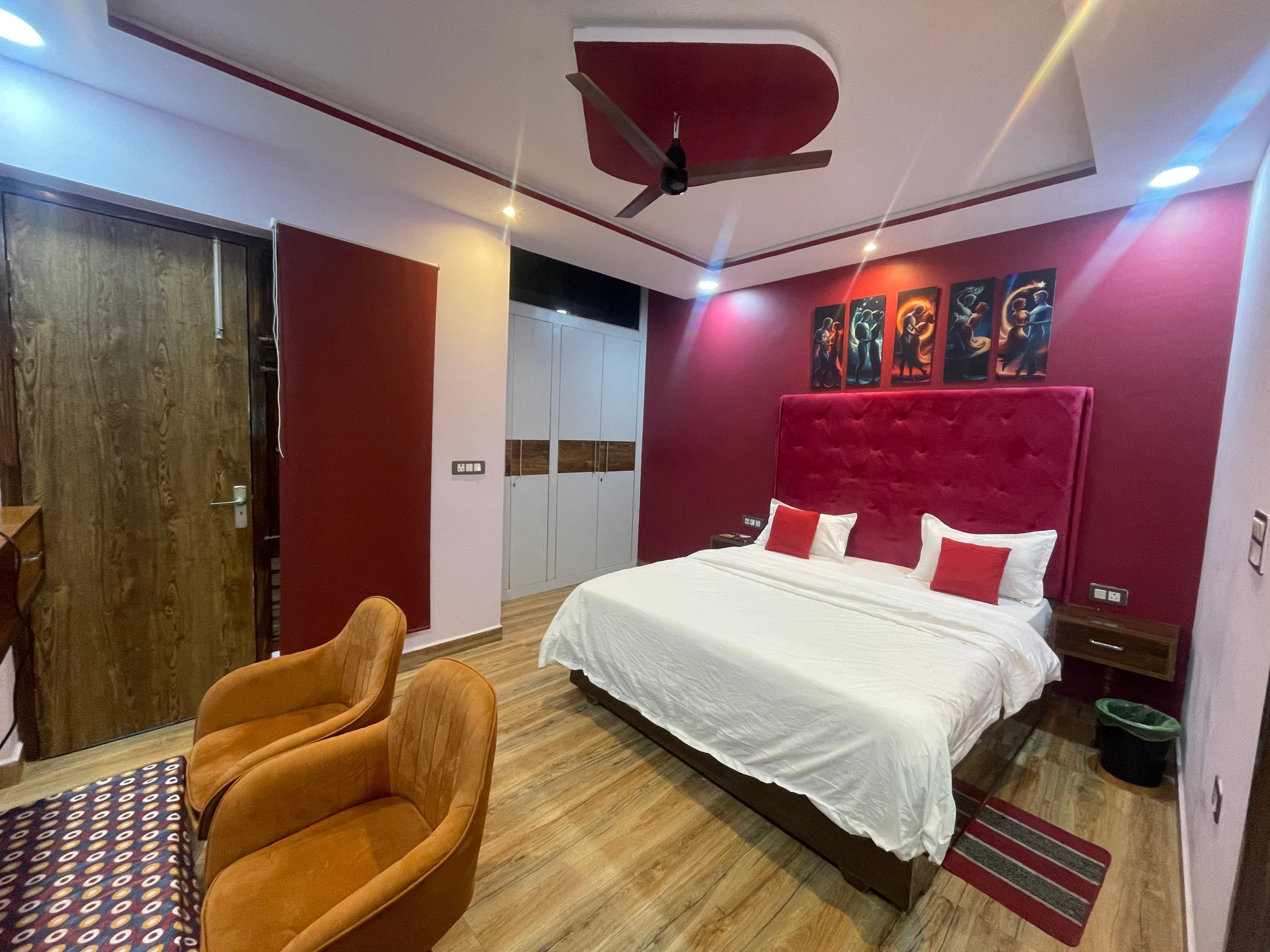 1BHK Private Flat bedroom at VMP Villa — king bed with red accent wall