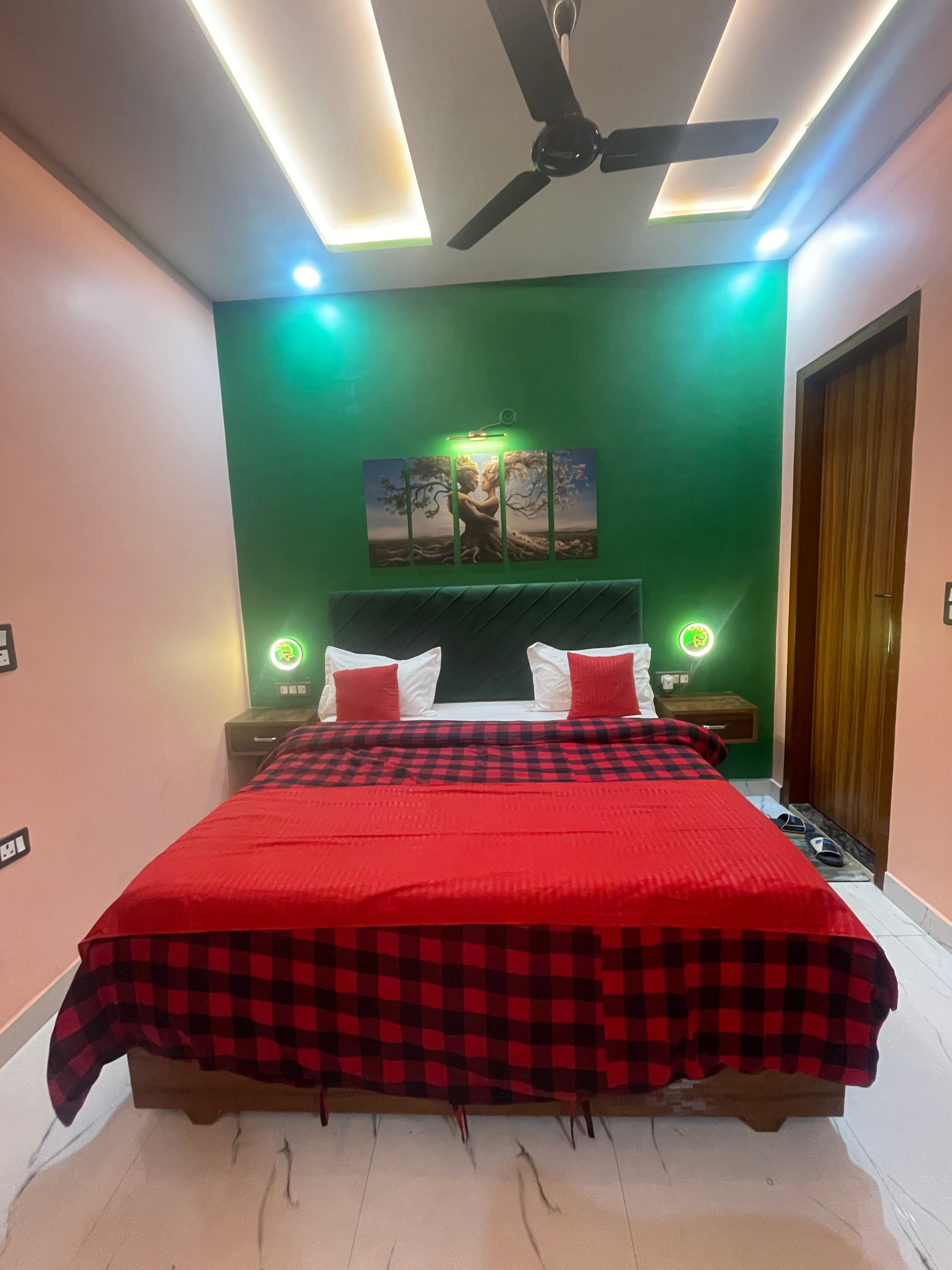 2BHK Private Flat bedroom at VMP Villa — green accent wall with LED lighting