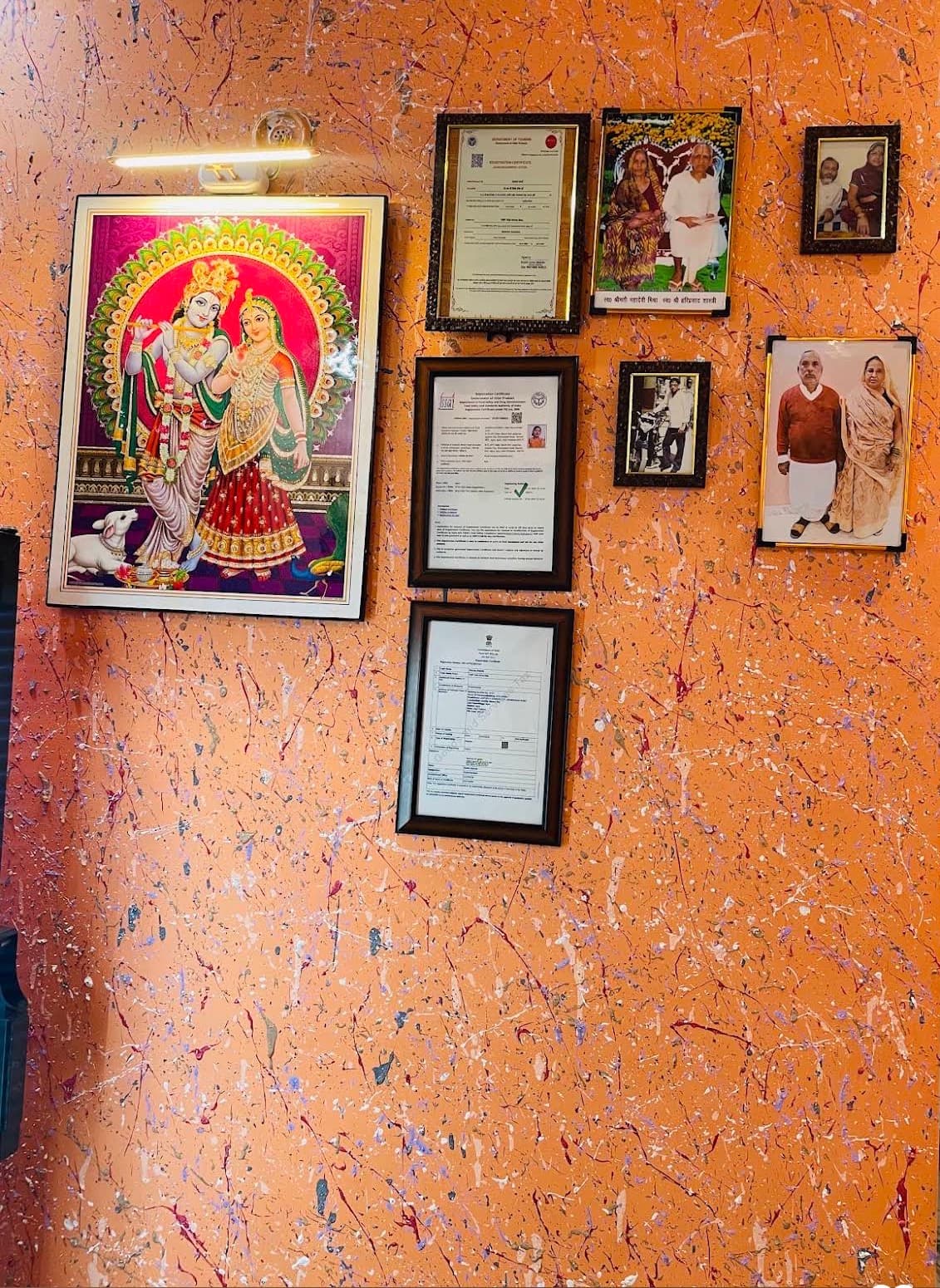 VMP Villa reception wall with Radha-Krishna painting and tourism registration certificate