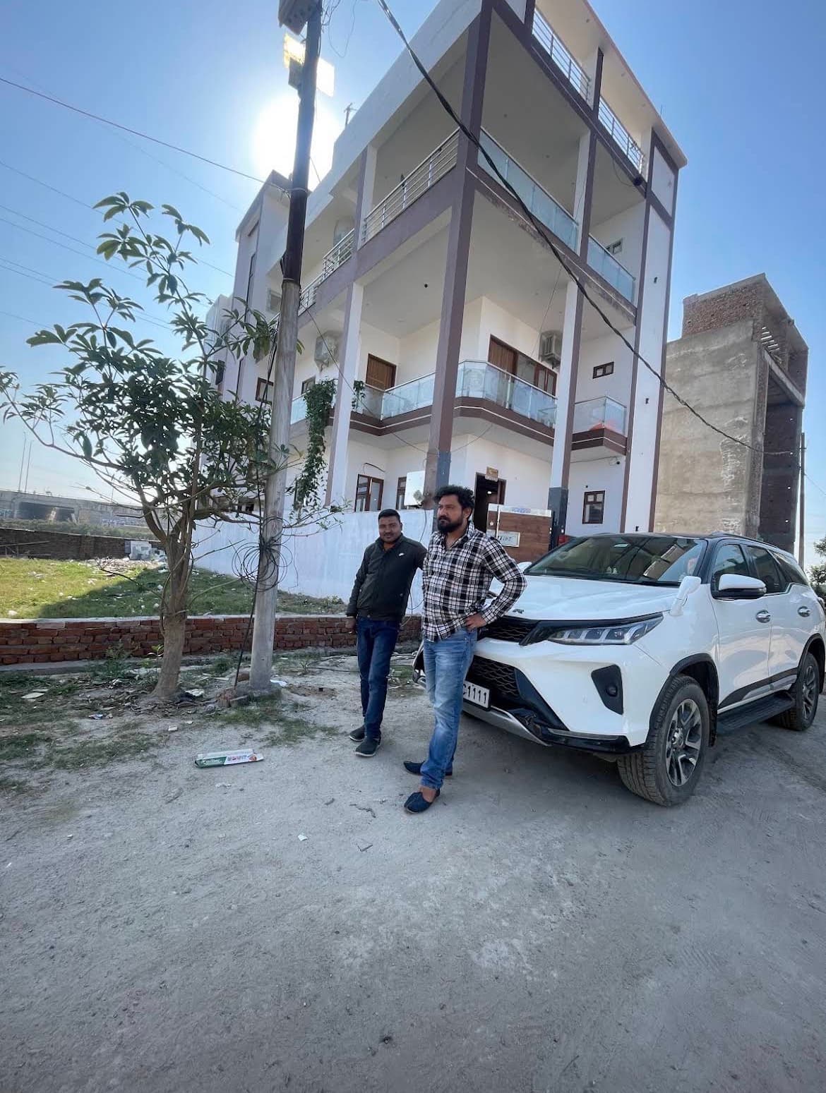 VMP Villa three-storey building exterior with SUV parked outside